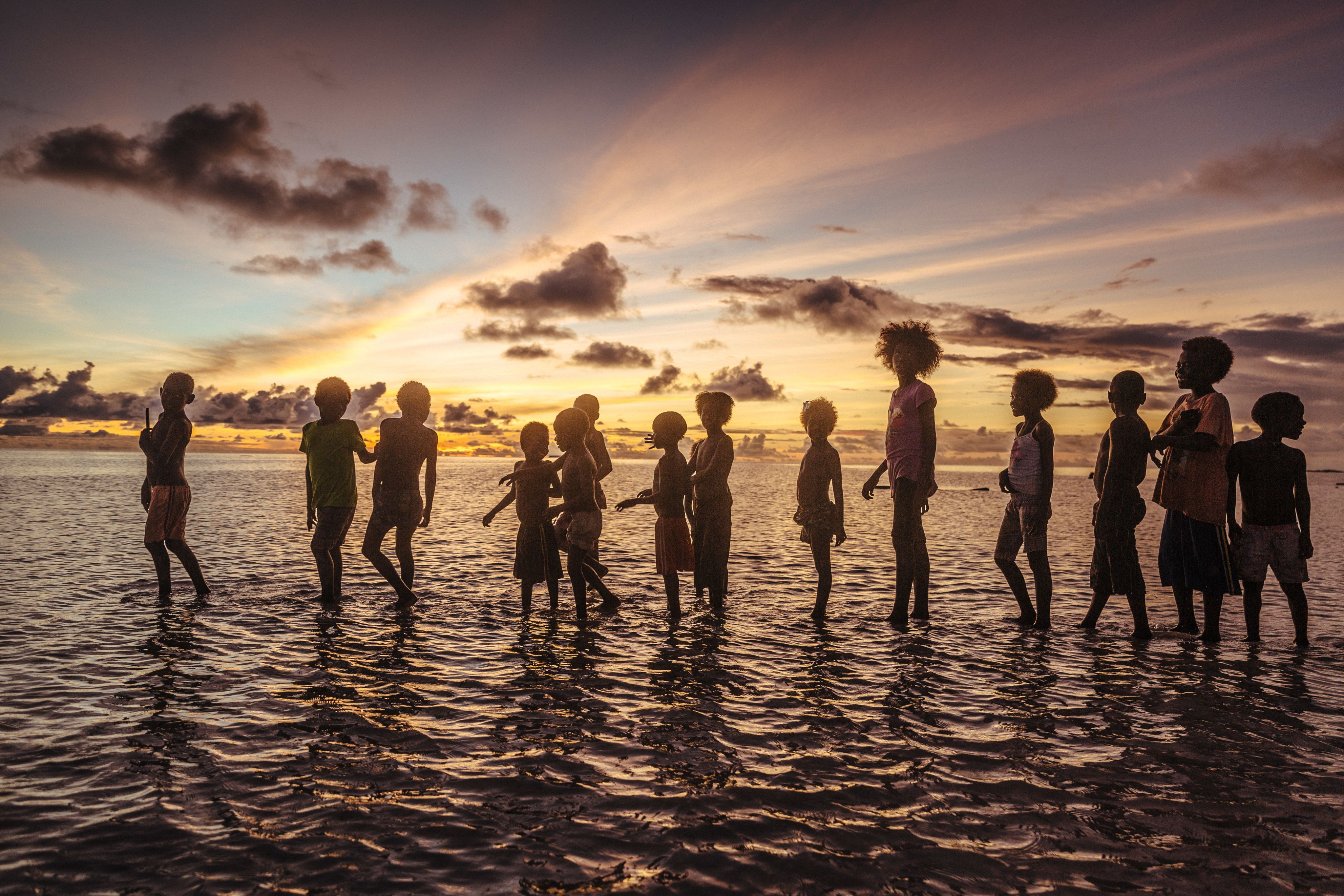 Children playing in the water, Carteret Islands, Papua New Guinea. 