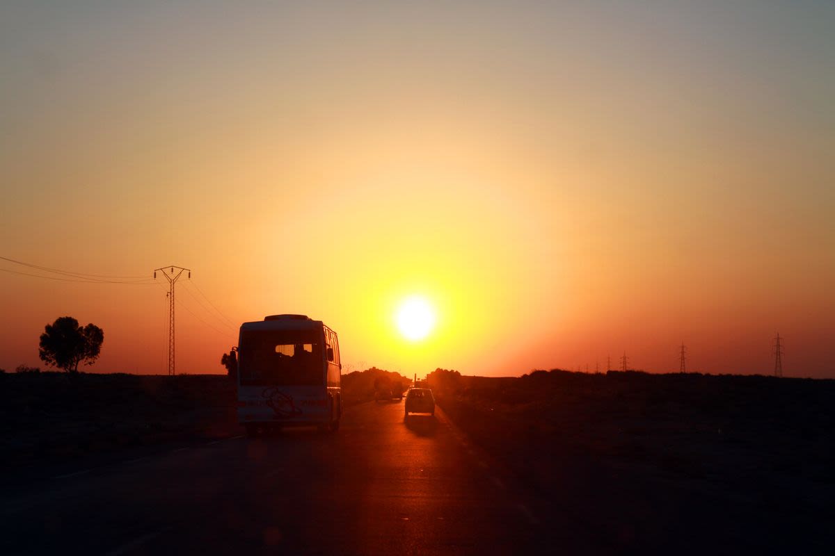 Vehicle silhouettes on sunrise