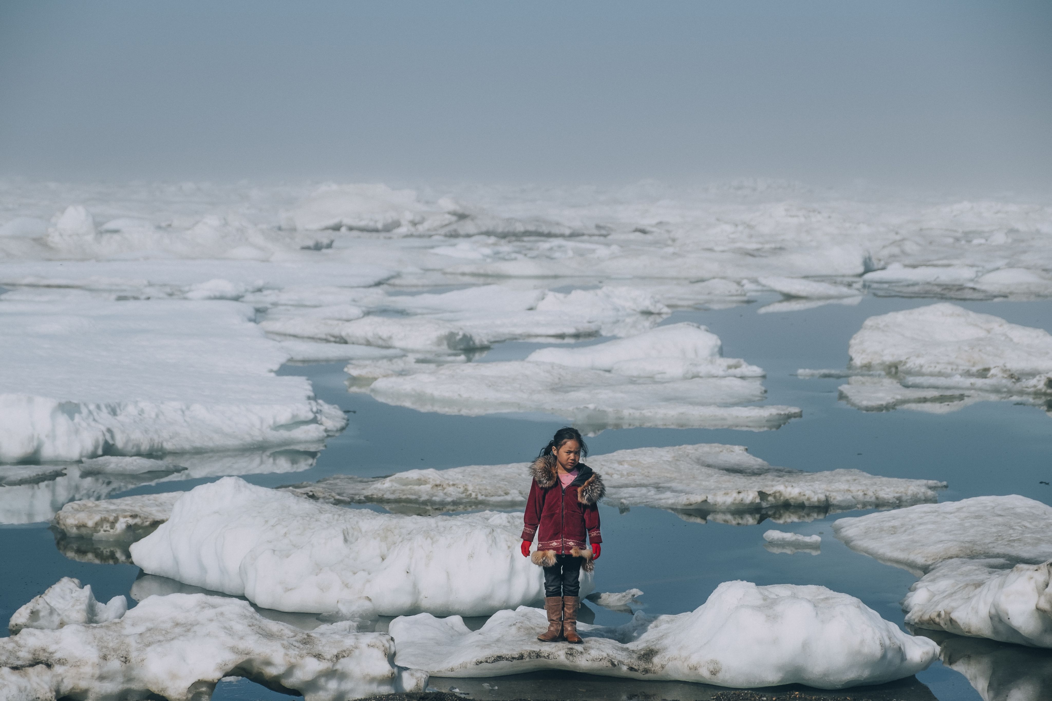 An Iñupiat girl Amaia, 11, standing on an ice floe in the Arctic Ocean in Barrow, Alaska. The anomalous melting of the Arctic ice is one of the many effects of global warming that has a serious impact on the lives of humans and wildlife.